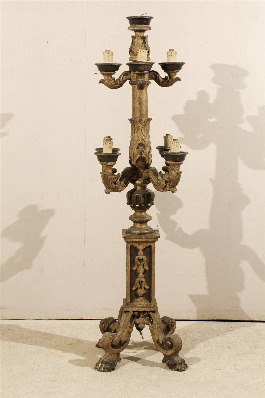An Italian 19th century large painted and delicately carved wooden floor candelabra on paw feet. In original untouched antique condition with paint over Gesso. This candelabra has the old European wiring, but is not wired for the US market.
 