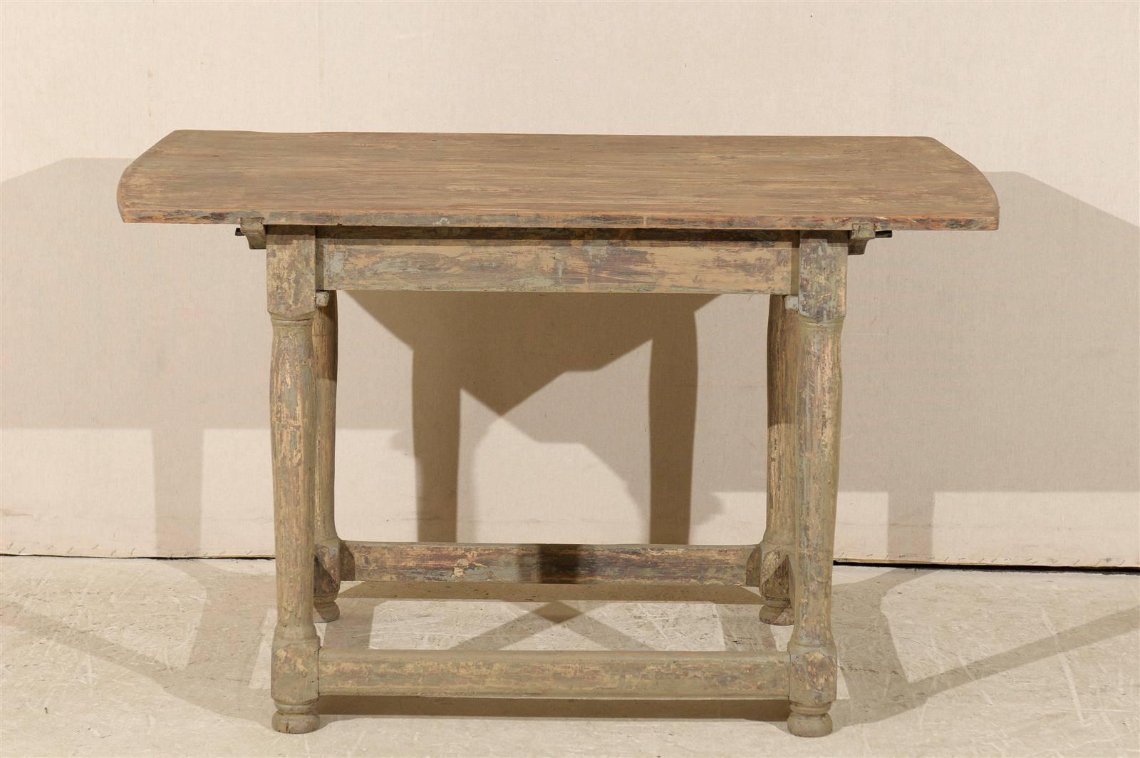 A Swedish early 19th century painted wood side table with remnants of original paint and side stretchers.
 