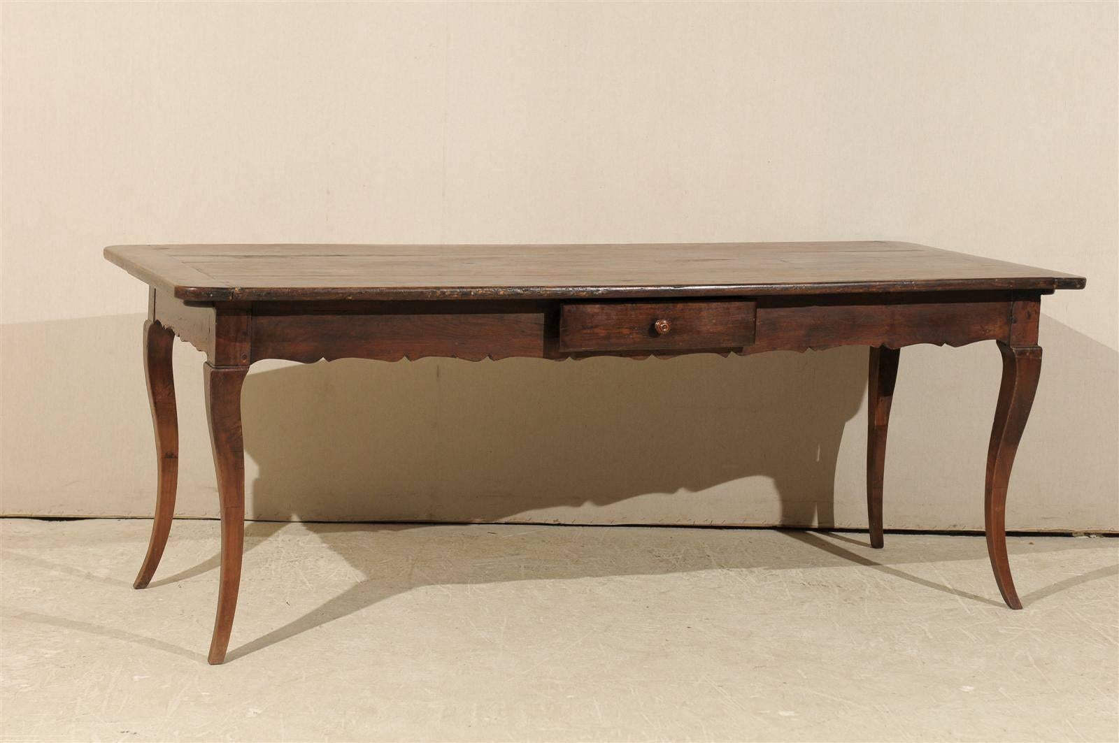 A French early 19th century fruitwood table/desk with single drawer, scalloped apron and cabriole legs.
     