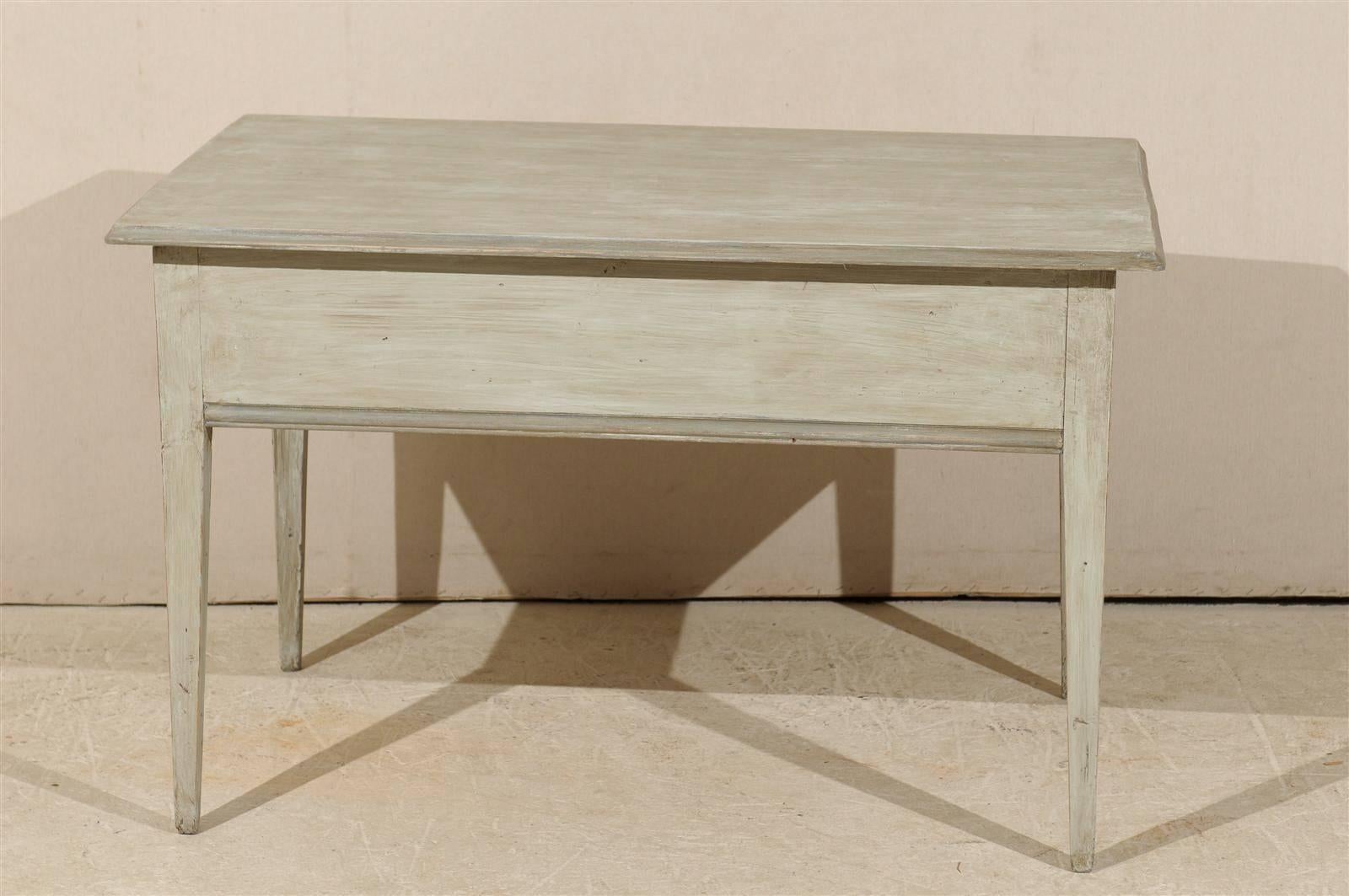 A Swedish 19th century painted wood side table with single drawer, tapered legs and clean lines.