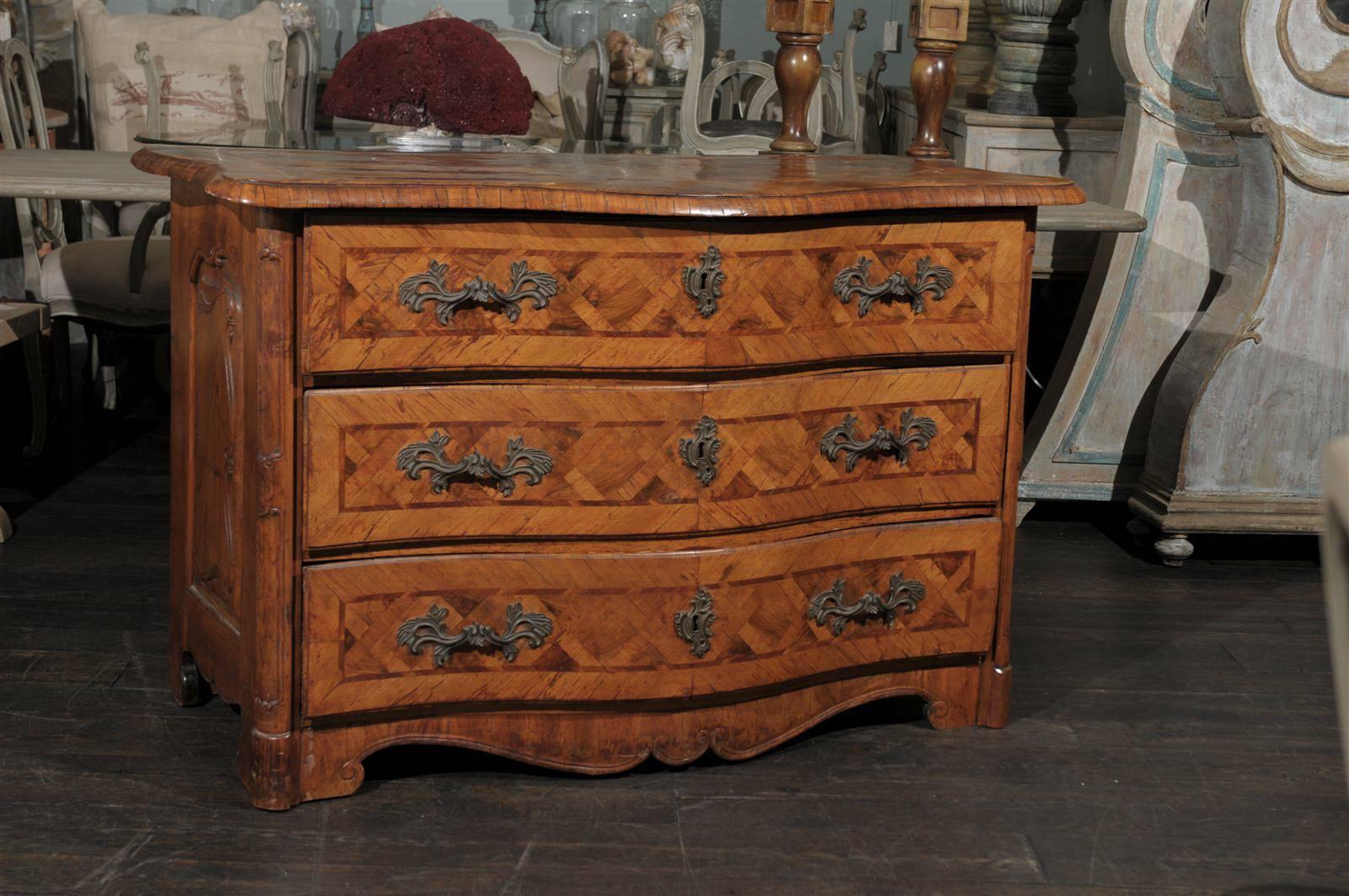 An Exquisite Early 18th Century Italian Period Baroque Three-Drawer Chest with Serpentine Front, Marquetry Décor on the Top and Drawers. This Chest also has Carved Side Panels and Side Posts as well as a beautifully scalloped skirt.