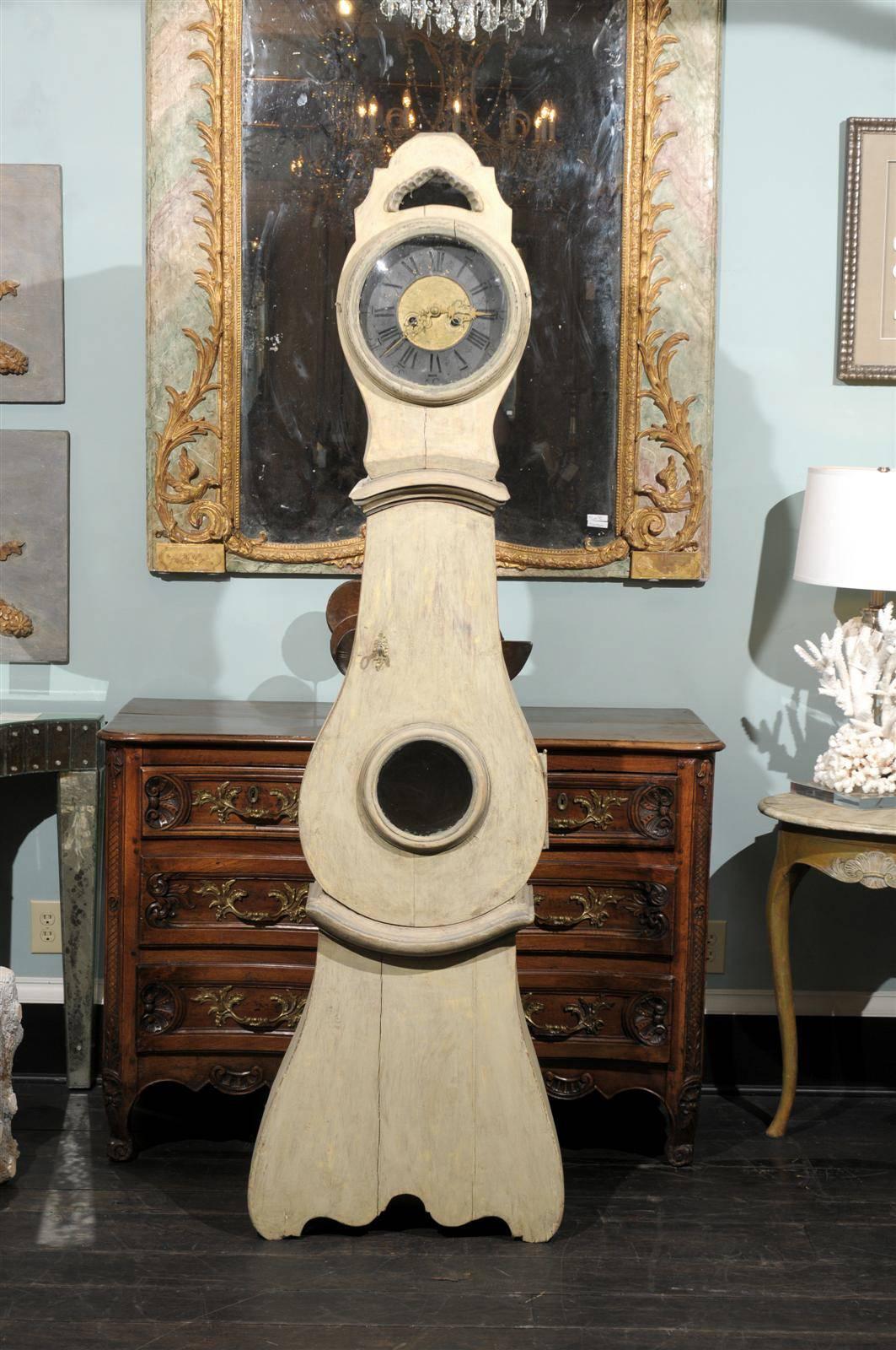 An exquisite 18th century painted wood Swedish clock. 

This is one of the prettiest clocks we have in our collection. With its pewter ring face featuring both roman and standard numerals, surrounding the central gilt section, its gorgeous gilded