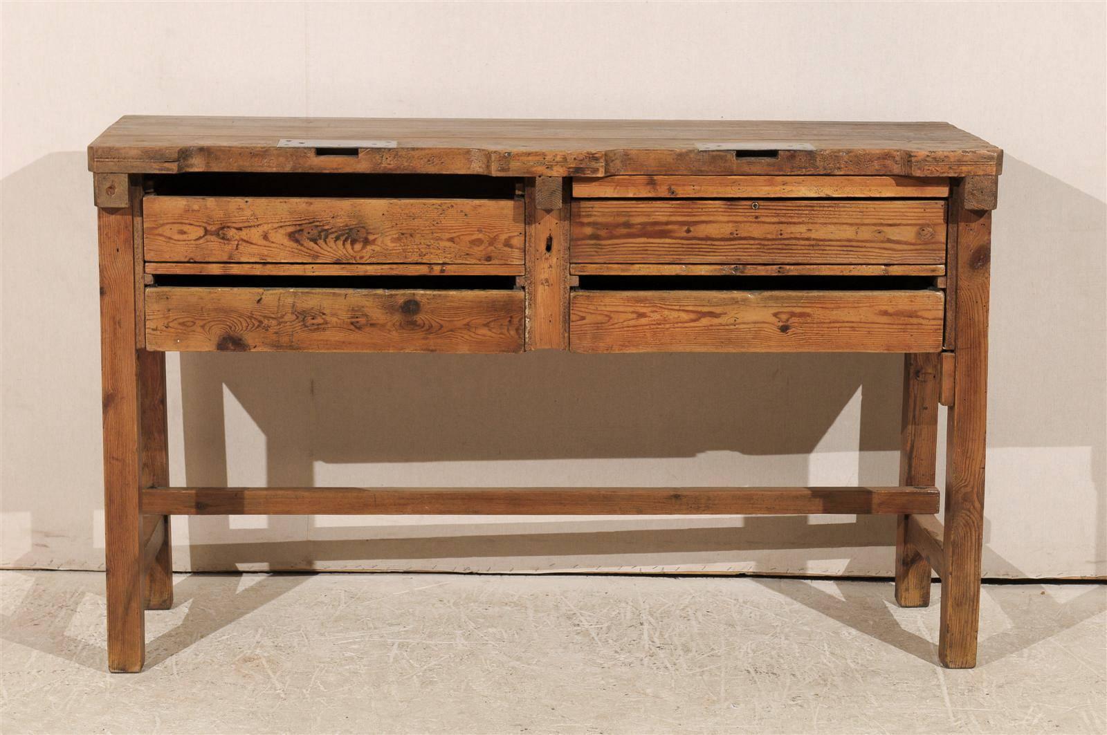 A 19th century jeweler's table or work bench.

This jeweler's table features a very linear and rustic profile. It has four drawers located in its front part separated with two pull-out shelves. Its legs are straight and joined by side stretchers.