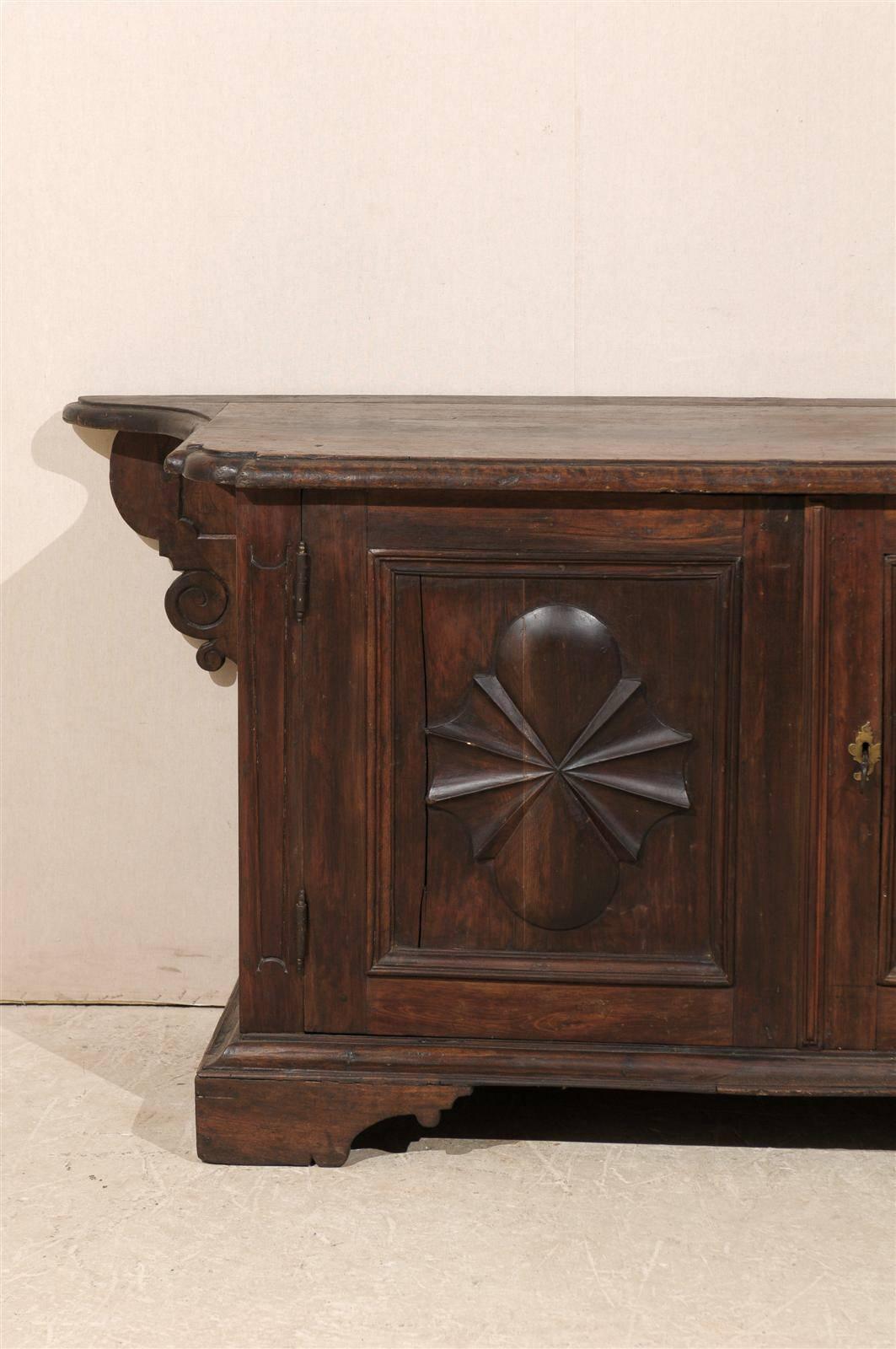 Carved 18th Century Italian Rich Walnut Wood Credenza with Sunburst and Volute Motifs