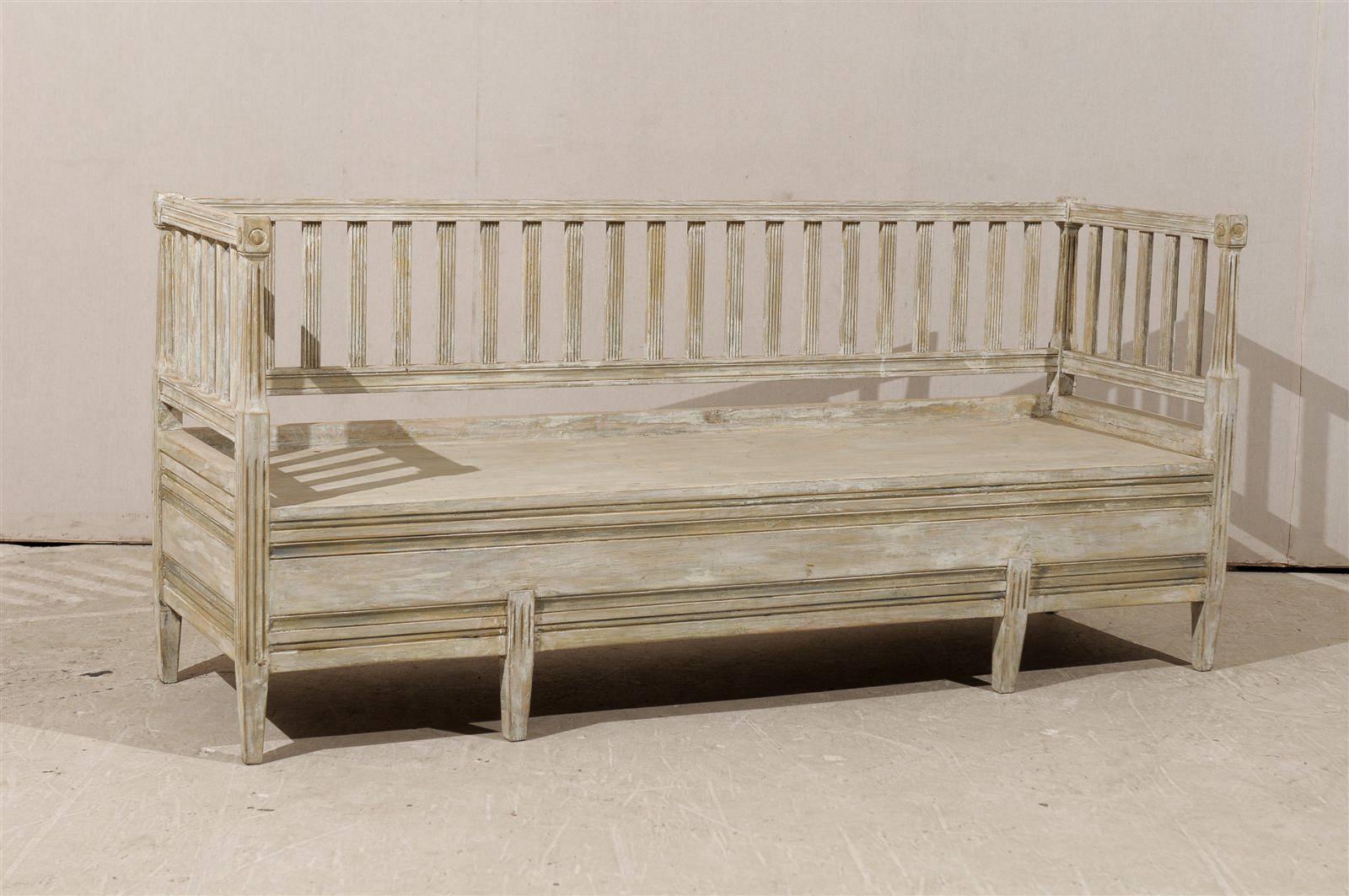 A Swedish late Gustavian Period, early 19th century painted wood bench. This Swedish painted wood bench features a linear profile with clean lines and pastel colors typical of the Swedish taste for light and soft colors which help bringing light to