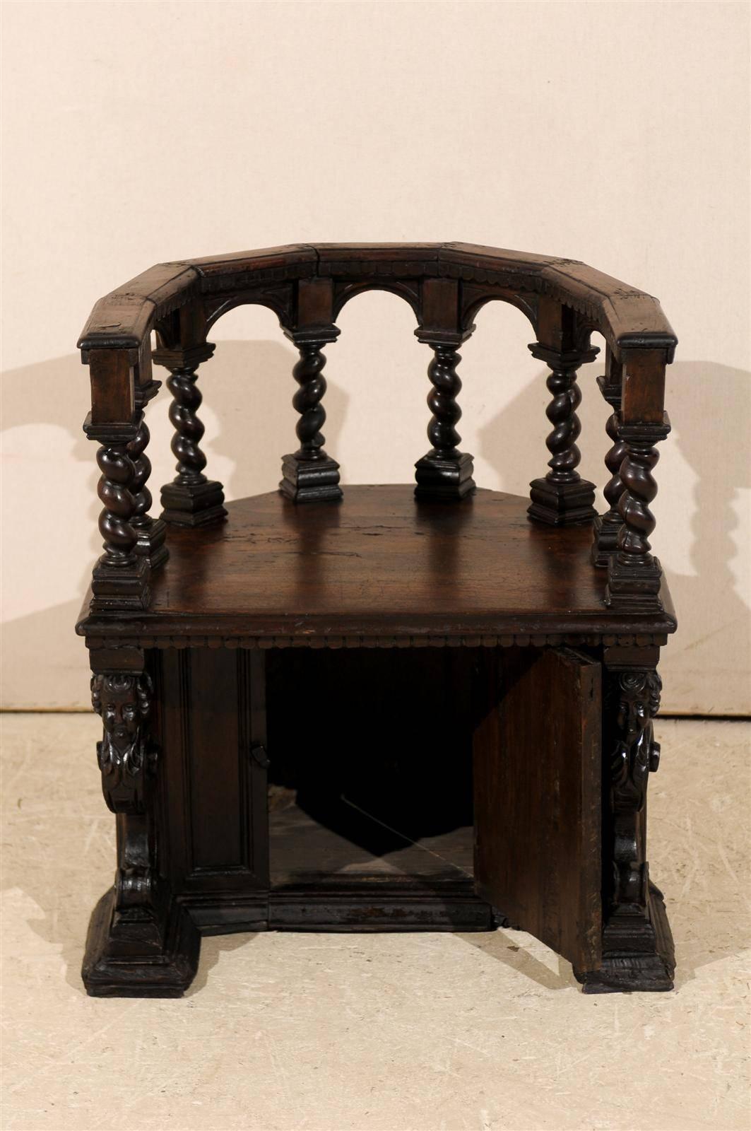 An exquisite 18th century Italian wooden carved round about chair with secret door at the bottom. Barley twist posts support the arched top rail while the lower section of the chair is decorated with faces of chubby putti on volutes. Guarded by the