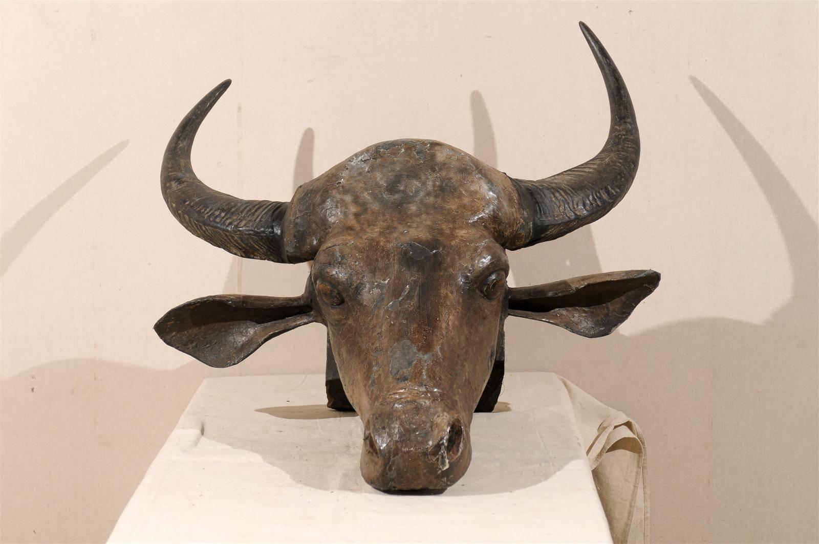 A hand carved and crafted water buffalo head wall mount sculpture from Kerala, Southern India.  Made of a composite of papier mâché, resin and paint. 
 The horns are real water buffalo horns, mid-20th century.  This unique piece has wonderful detail