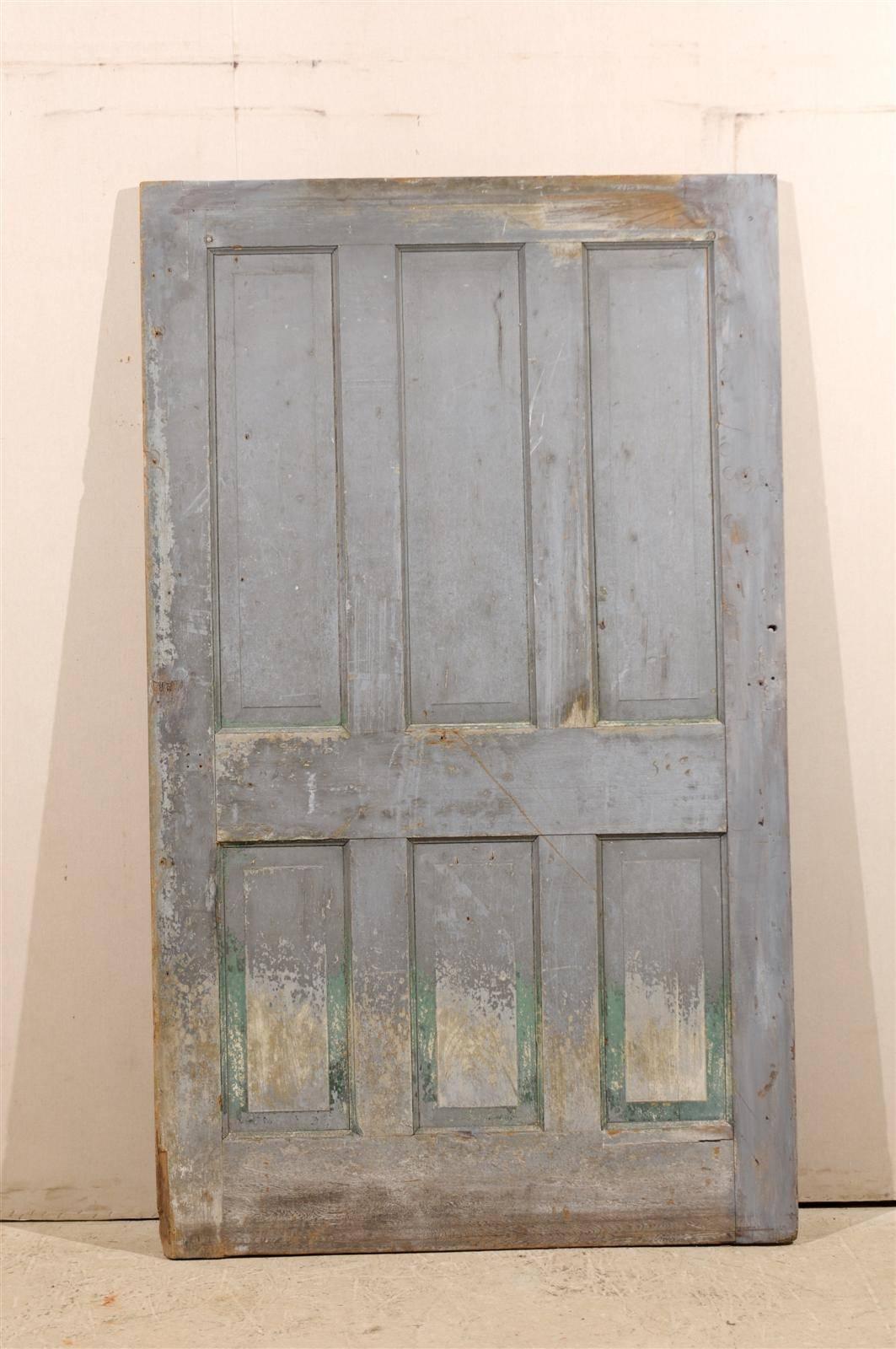 A single oversized six-panel door with original finish. Nice grey color with some green and wood coming through. Nice aging.