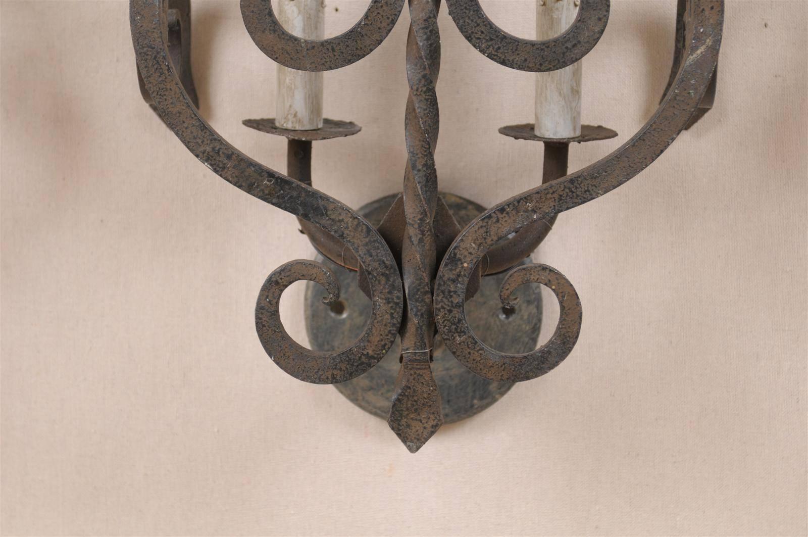 A Set of Three French Two-Light Forged Iron Sconces Featuring Scroll Decor 1