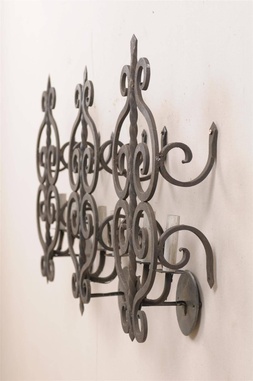A Set of Three French Two-Light Forged Iron Sconces Featuring Scroll Decor In Good Condition In Atlanta, GA