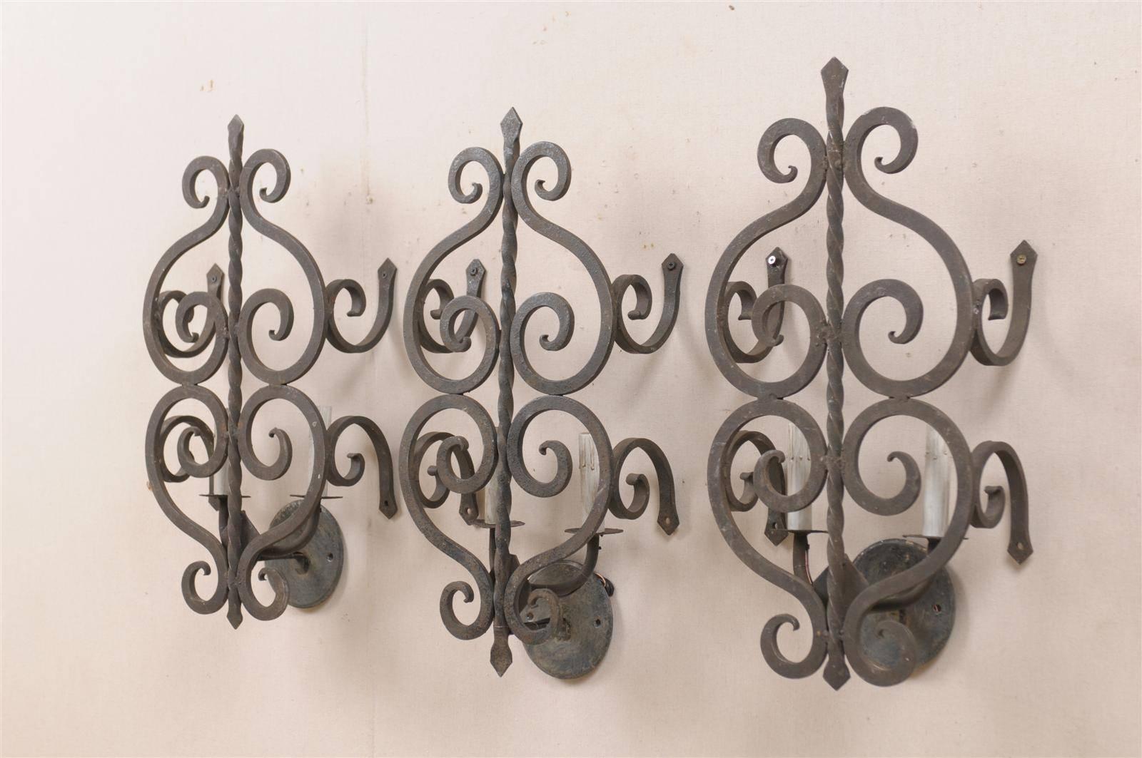 Mid-Century Modern A Set of Three French Two-Light Forged Iron Sconces Featuring Scroll Decor