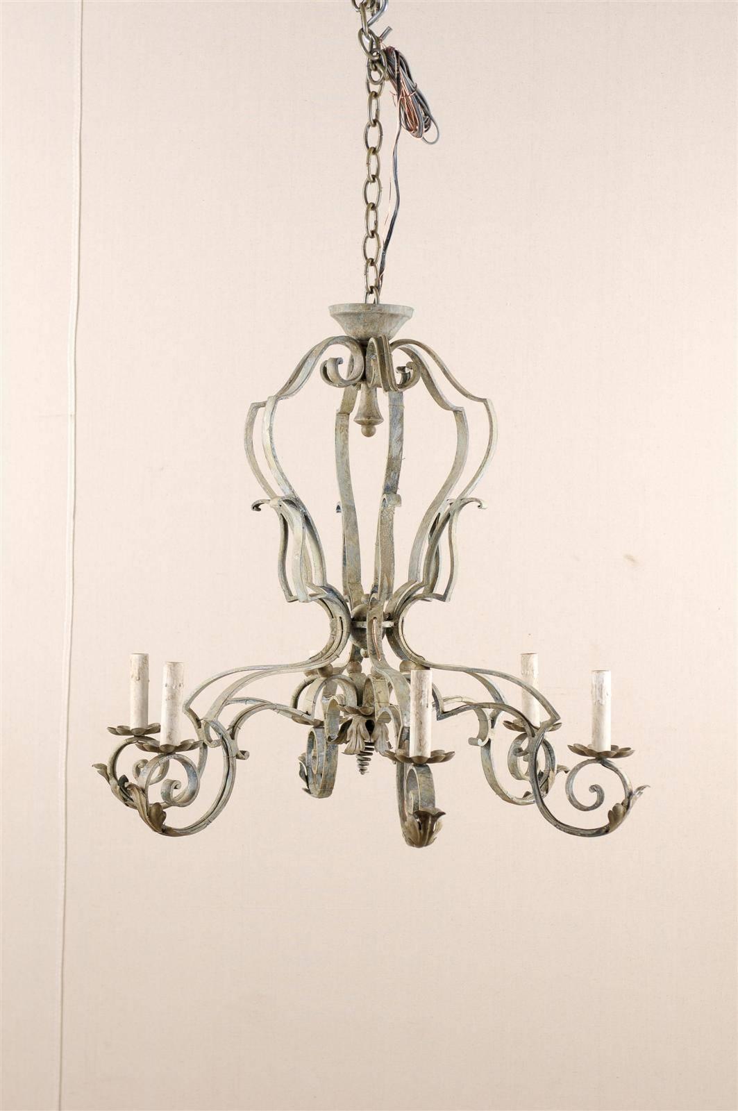A French painted iron six-light chandelier. This French vintage mid-20th century chandelier is made of a scrolled armature and arms. Acanthus leaves decorate the arms under the flower-shaped bobèches. This French chandelier has been rewired for the