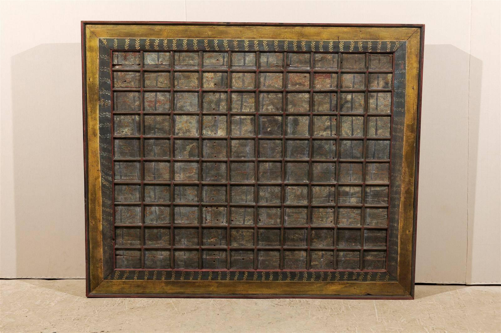 A 19th century carved wood southern Indian decorative ceiling panel. This wooden ceiling panel from the Tamil Nadu state features a delicate decor of painted flowers in the coffered sections. The surround is also decorated with floral motifs. The