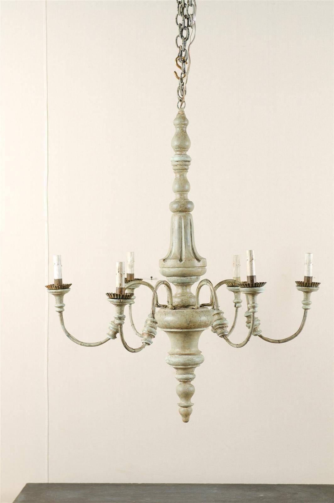 An Italian six-light chandelier from the mid-20th century. This Italian chandelier features a turned style central column with swoop arms. The central column is turned. The chandelier is a soft grey-green color with light blue accents throughout.