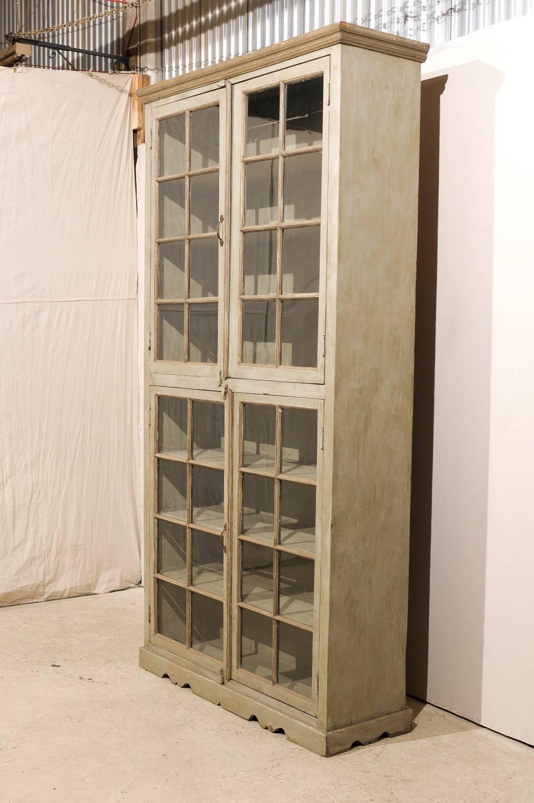 tall narrow display cabinet with glass doors