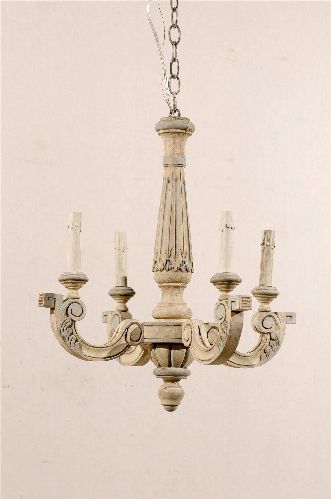 A French four-light painted and carved wood chandelier with thin central column and C-scrolled arms ornate with discreet leaf motif and terminated by a geometrical volute. From the mid-20th century, this French chandelier has been rewired for the US