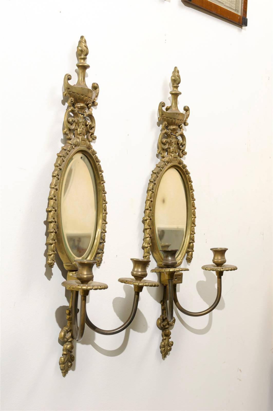 Carved Pair of Early 20th Century Gilded Sconces with Oval Shape and Beveled Mirror
