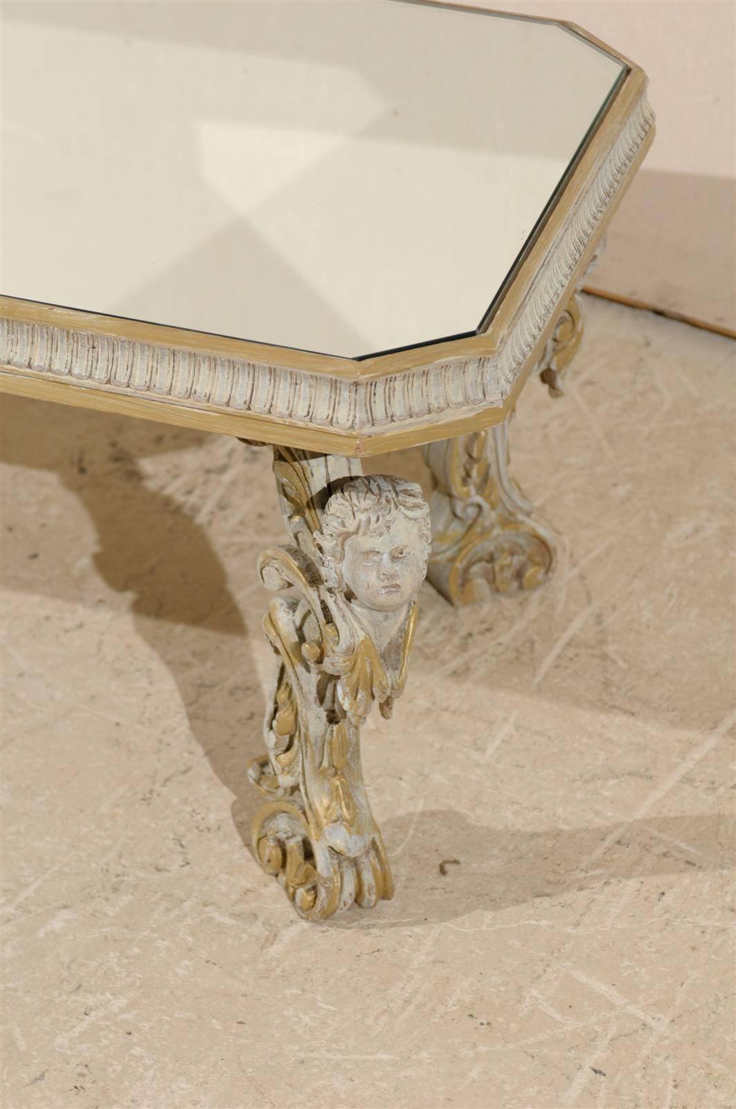 Painted Italian Mirrored Top Coffee Table with Ornate Putti Carved Legs, Circa 1920s For Sale