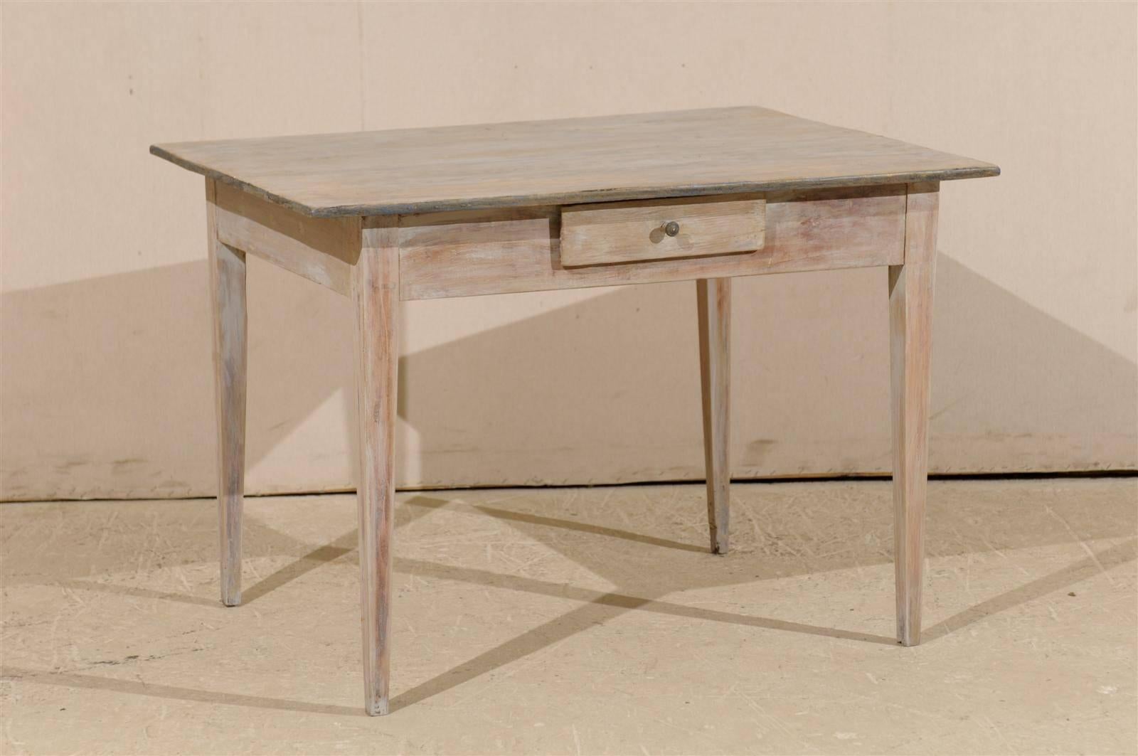A Swedish early 19th century period Gustavian table. This Swedish side table with single drawer and whitewash finish with wood coming through, is raised on four tapered legs.