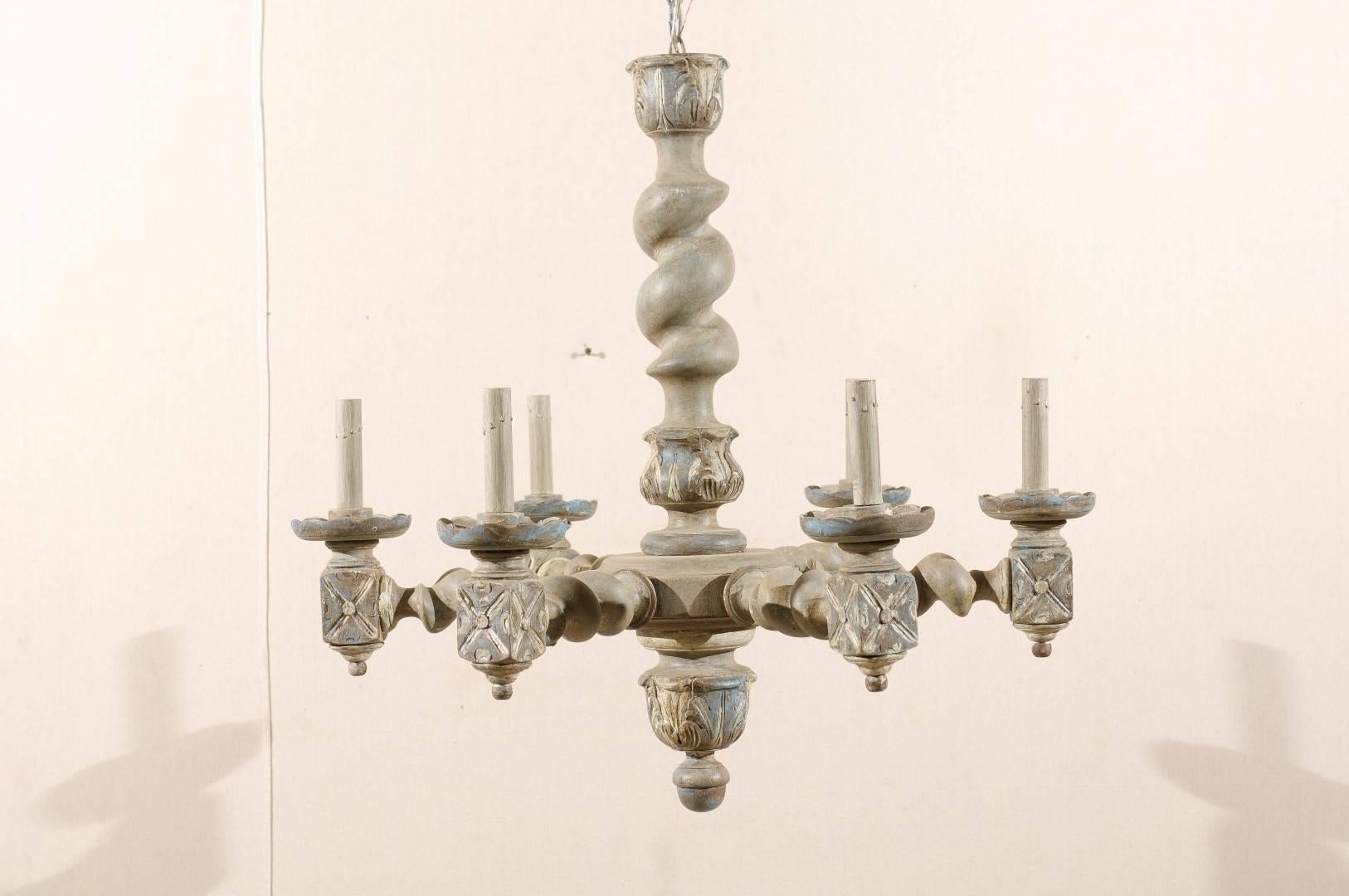 A French six-light barley twist wooden chandelier. This French vintage painted wood chandelier features a central barley twist column with acanthus leaf motifs. Six barley twist arms are connected to the central ring. The wooden bobèches are
