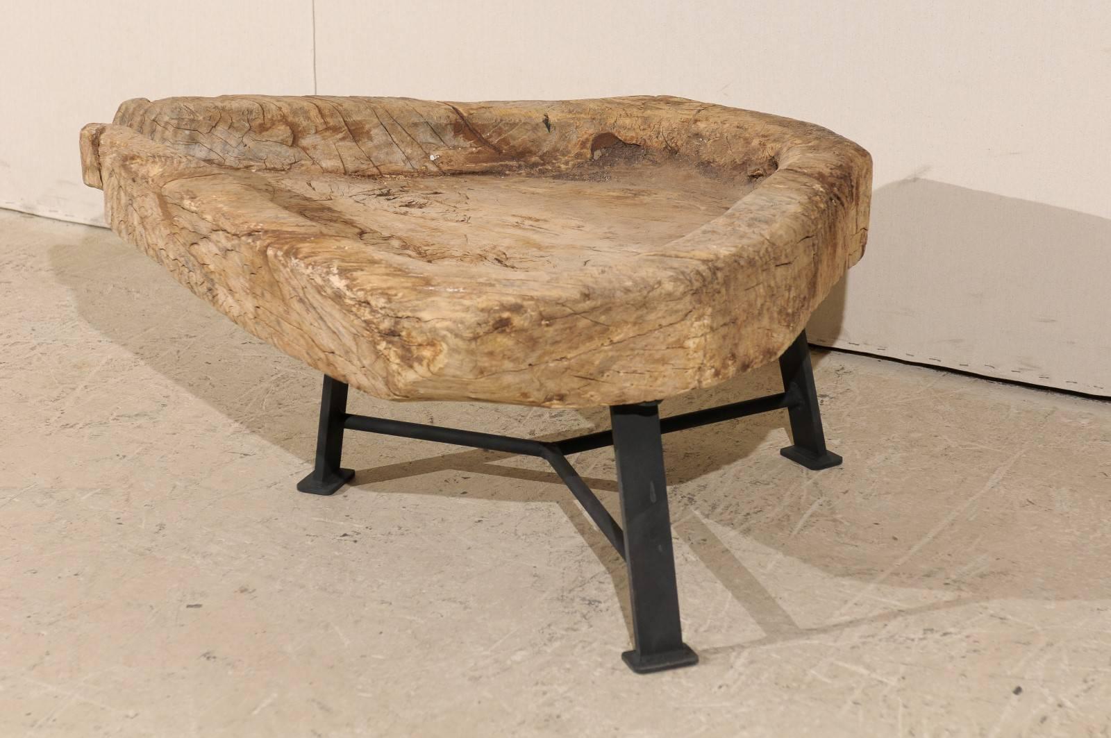 A Guatemalan rustic cheese making table raised on newer custom metal base, from the late 19th, early 20th century. This antique wooden cheese making table originally used in Guatemala has a new custom metal Stand and thus, new purpose. This old