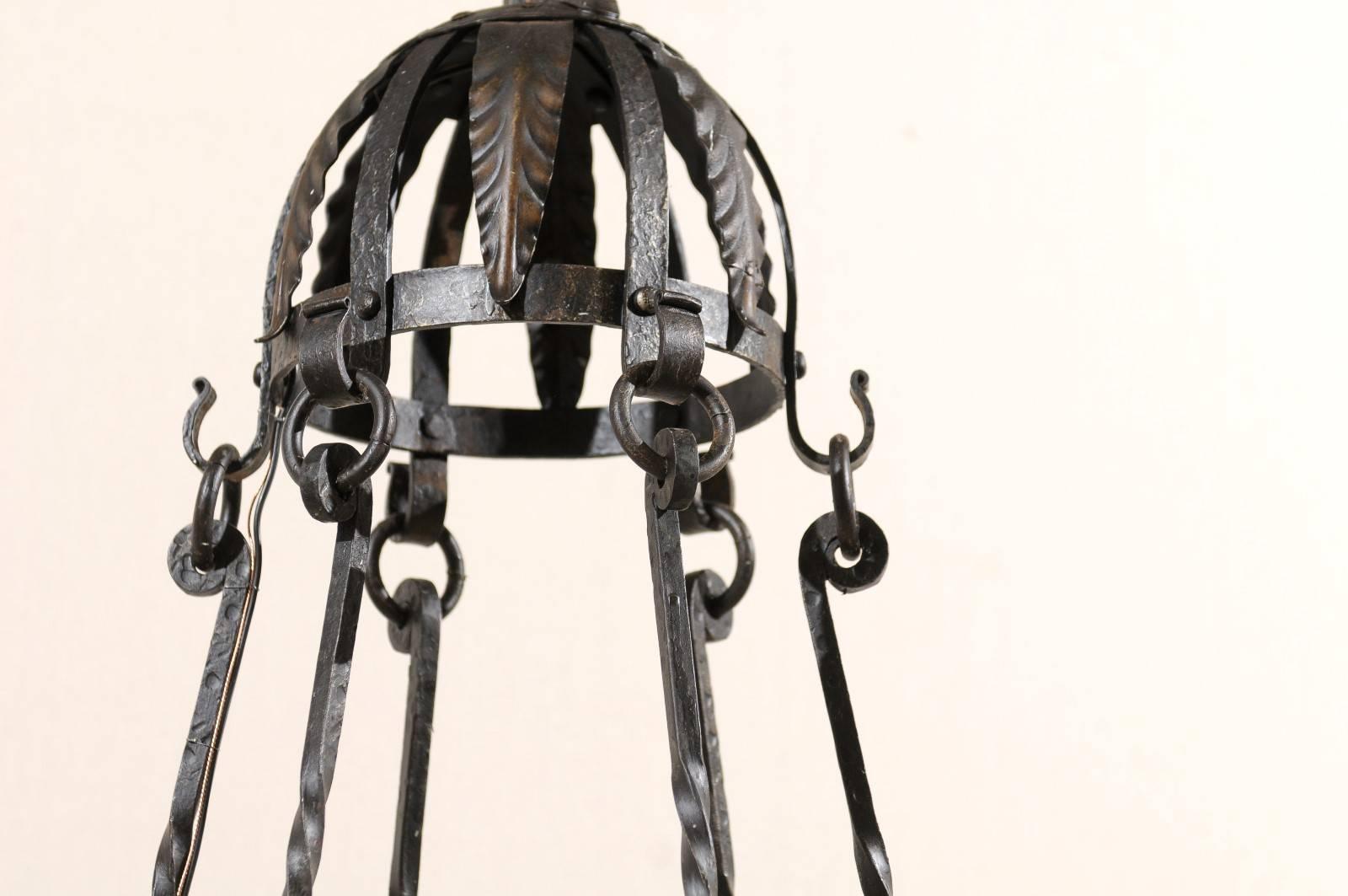 Mid-Century Modern Italian Six-Light Black Iron Ring Chandelier with Scroll Motifs and Domed Canopy For Sale