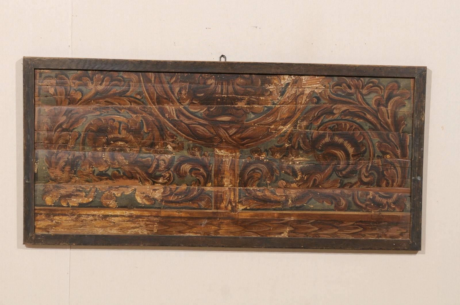 An Italian 18th century rectangular ceiling panel re-purposed into a wall decoration. This large size Italian richly painted wood ceiling panel features a décor of rinceaux / foliage. This piece is painted with rich, warm copper-brown tones. It