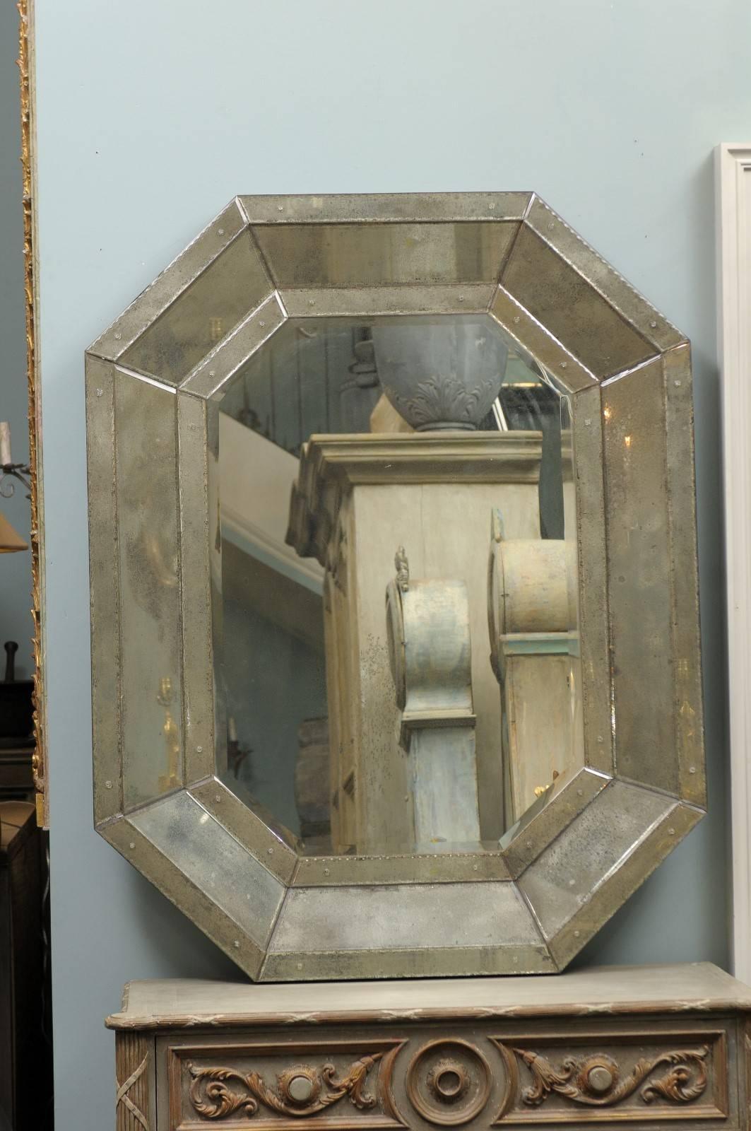 The Octagonal Venetian style mirror. The octagonal mirror features a beveled frame converging nicely towards the center, giving a lot of depth and life to the piece. It has been skillfully handmade and hand -silvered. The central glass panel is