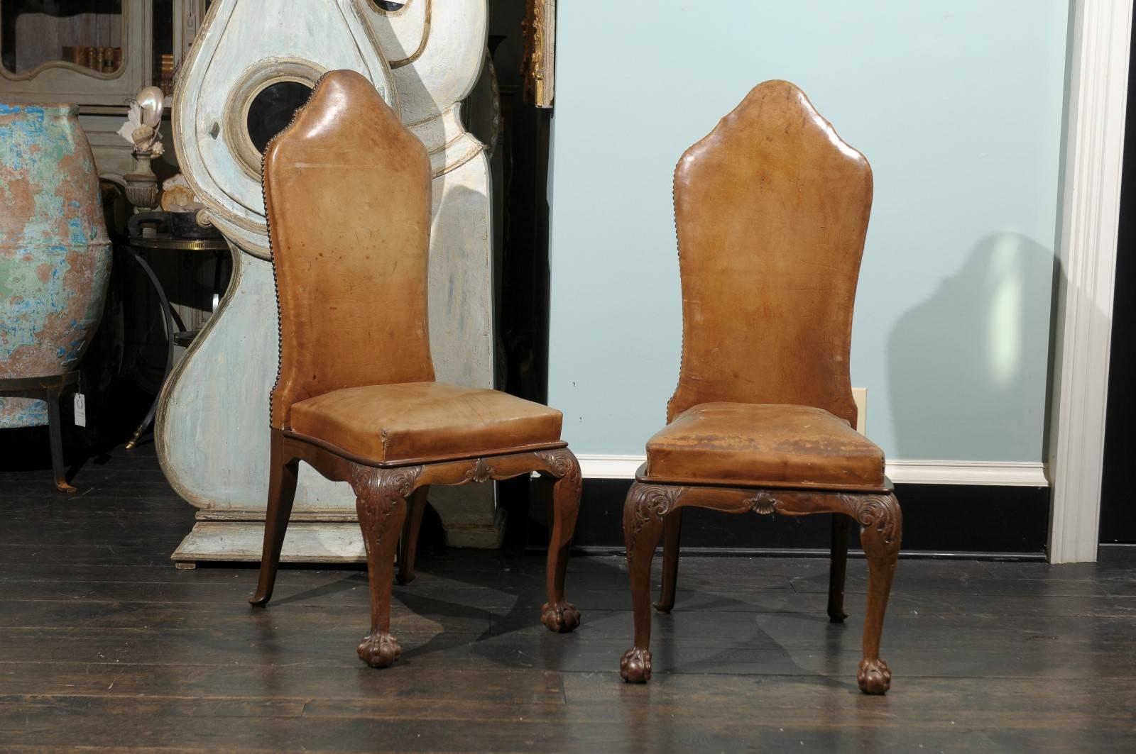 A set of eight Italian 19th century leather chairs. These William and Mary style Italian chairs feature nailhead surrounds, cabriole legs and claw-and-ball feet. The backs and seats of the chairs have a caramel tone leather upholstery. The seat