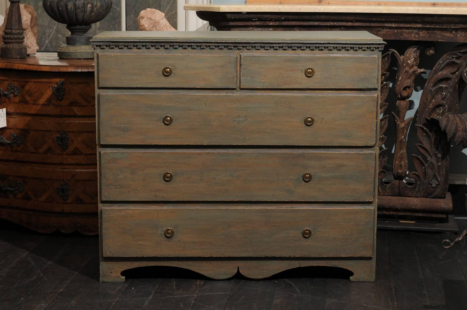 A Swedish early 19th century Karl Johan five drawers painted wood chest. This chest is dark grey-green in color with taupe undertones as well as darker blue trim. This Swedish chest from circa 1830-1840 features two smaller drawers over three larger