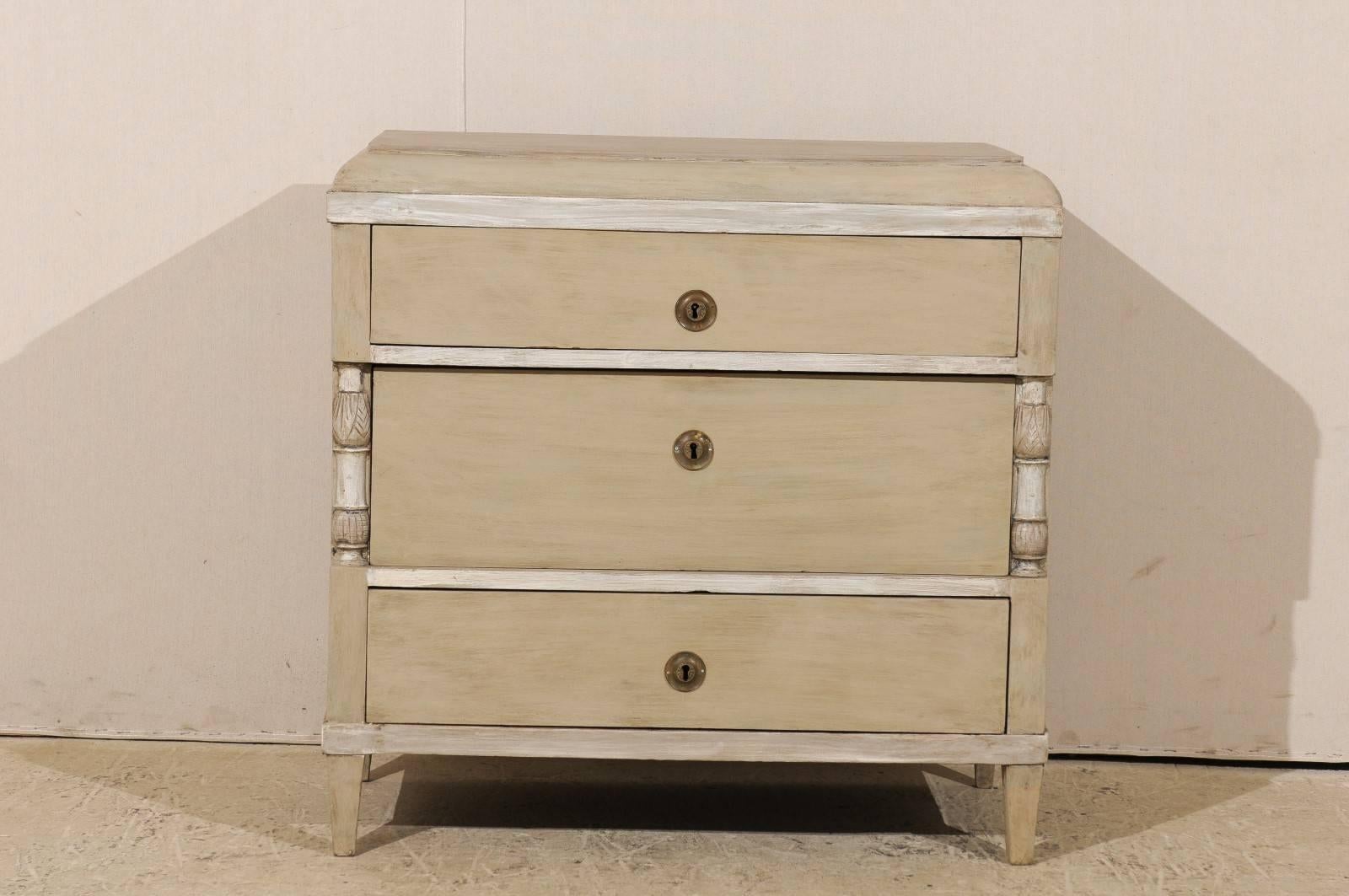 A Swedish mid-19th century chest with nicely dovetailed drawers. This Swedish painted wood three-drawer chest has a slightly raised top with gentle sloping out and down towards the main body which features a recessed middle drawer. The simple rather