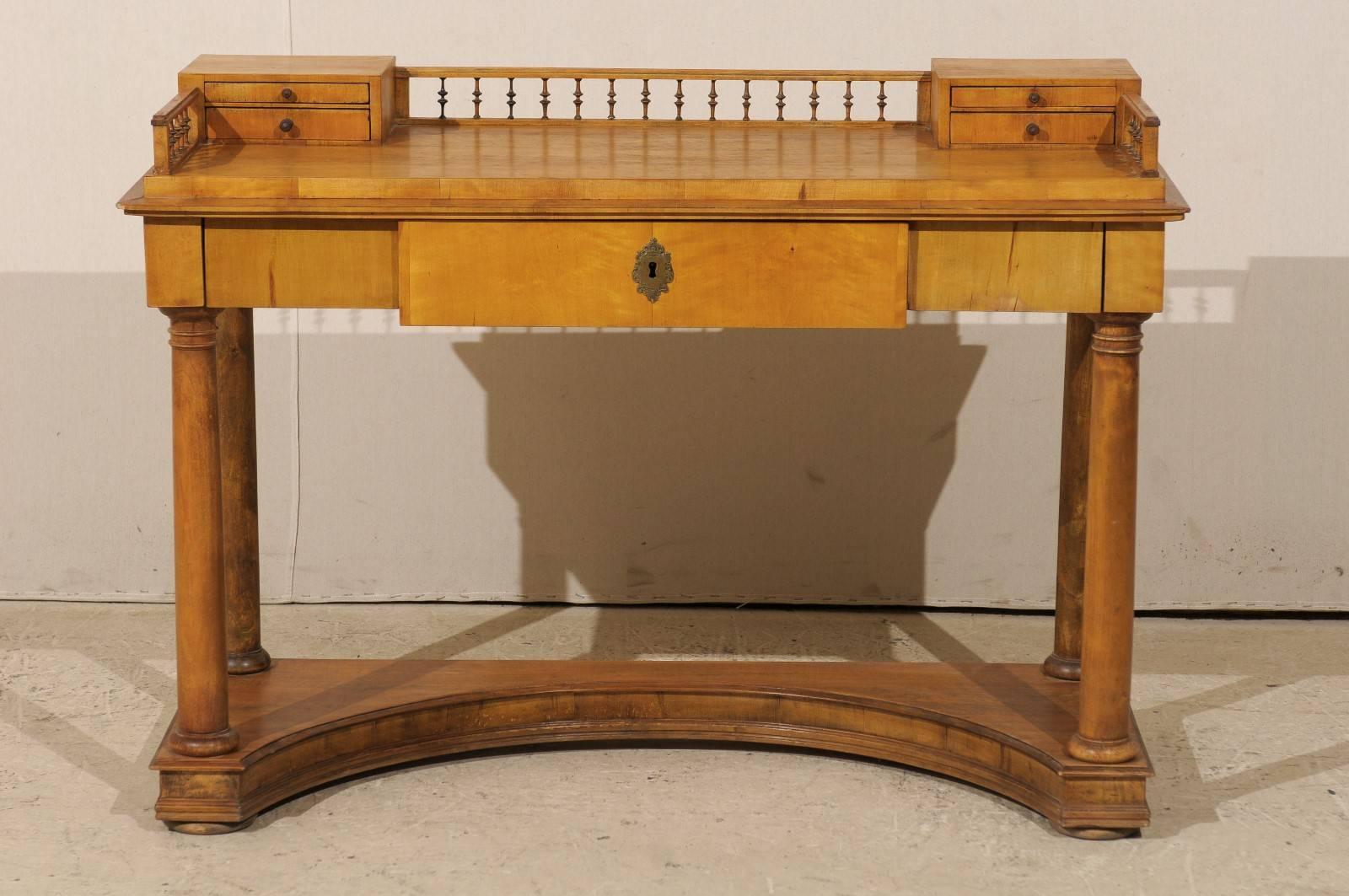 A Swedish 19th century Karl Johan period birch wood desk. This Swedish desk from circa 1830 features a writing area decorated with two small size drawers flanking a small open gallery reminiscent of turned spindles, also delimiting the area on both