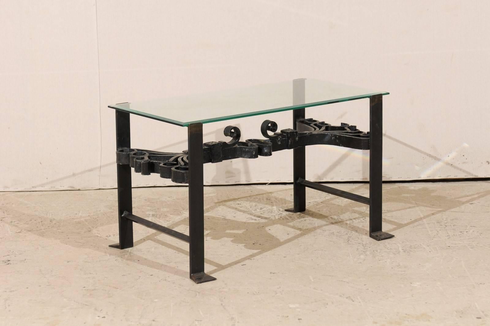 Table basse italienne en fer forgé de couleur noire avec plateau en verre et volutes ornées en vente 1