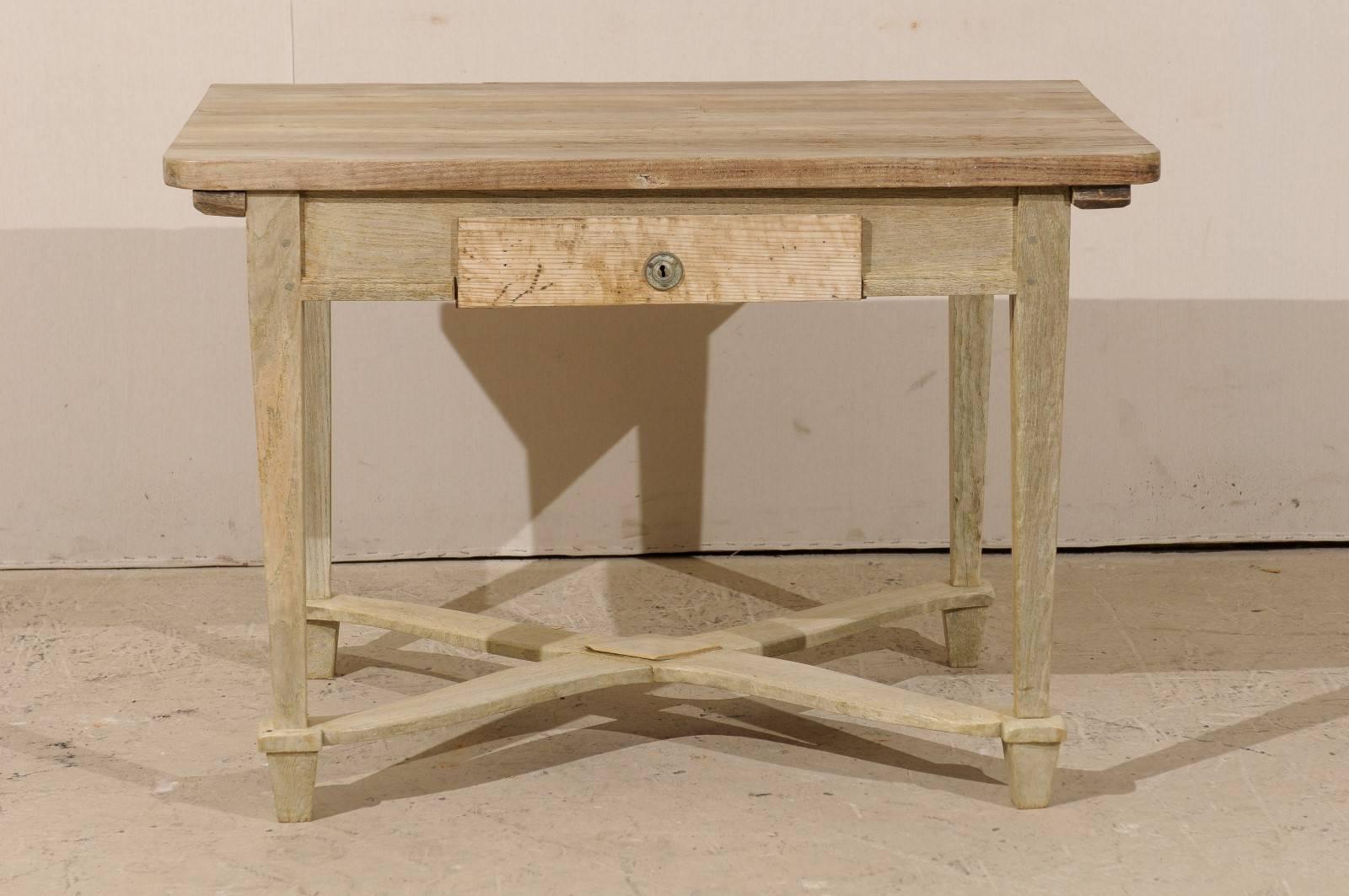A Belgian 19th century side table or desk. This Belgian rectangular table features a single drawer, nice clean lines, slightly tapered legs with a center cross stretcher that features a diamond motif in its center. This medium sized table would also