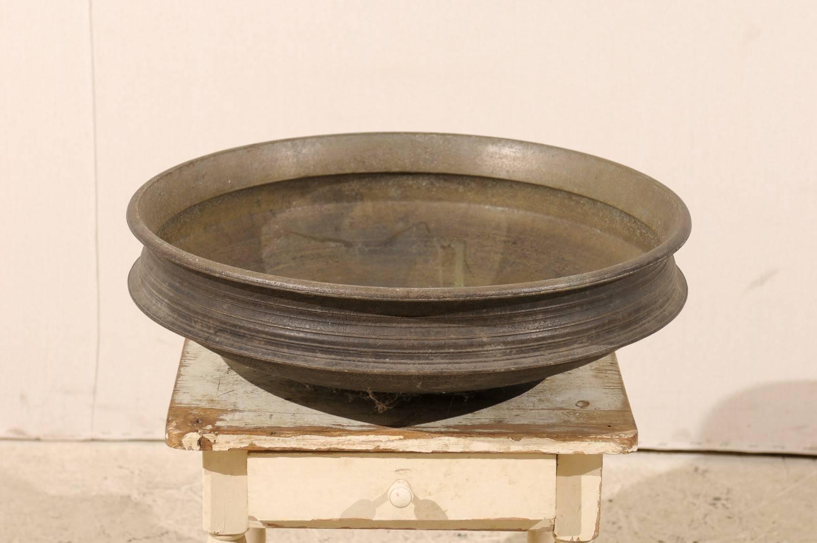An Uruli vessel from Southern India. This Uruli, from the early 20th century, is made of bell metal. Urulis are vessels which are circular in shape and shallow in depth, and were typically traditional cookware extensively used in southern India.