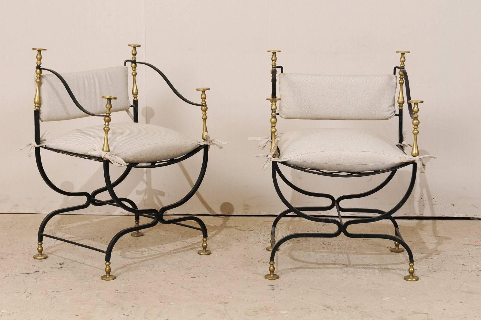 An almost pair of Italian Mid-Century Curule style chairs. This pair Italian chairs from the mid-20th century feature brass and iron armature. The Curule style is denoted by the way in which the legs are joined or meet together in the middle with a