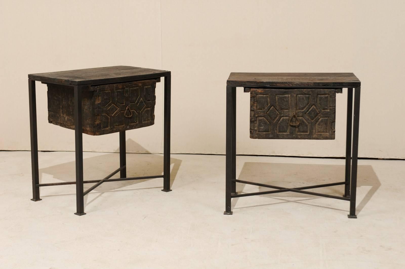 A pair of unique 18th century Spanish chests / side tables. This pair of 18th century (or earlier) Spanish drawers have been set into a custom iron base and older wood tops to produce this fantastic pair of statement pieces. The tops and drawers are