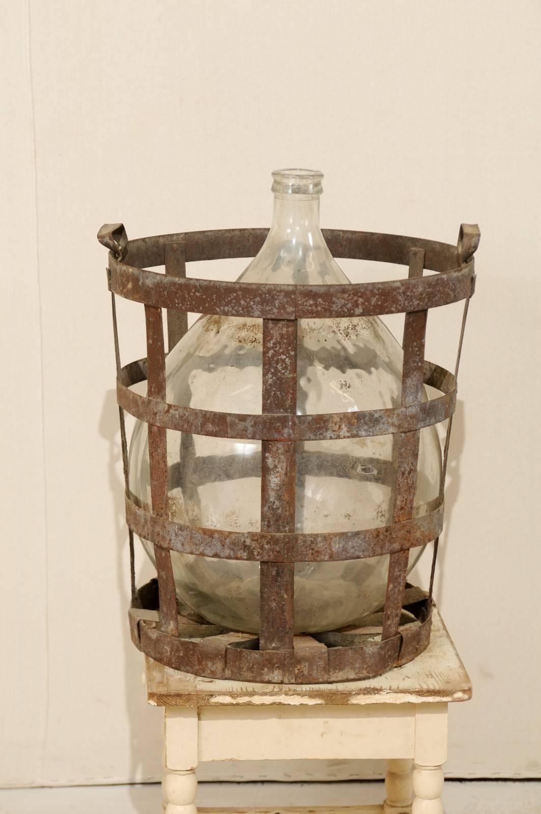 Mid-Century French Patinated Vintner Iron Basket with Demijohn Wine Bottle In Good Condition In Atlanta, GA