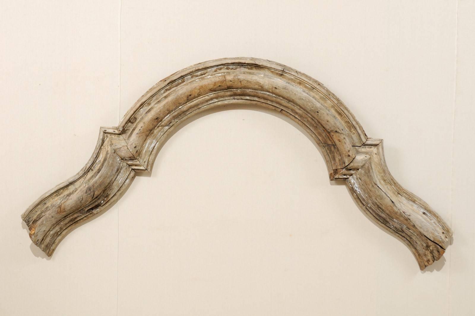 A large-sized Italian architectural ornament with overall arching bracket shape from the late 18th century. This large-scale Italian carved wood architectural ornament has a convex shaped arch with natural wood finish. This piece is in very good,