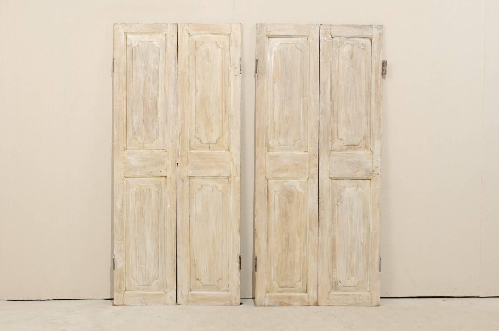 A pair of 19th century French doors. There are two pairs in the photographs, we now have only one pair available. This exquisite pair of French doors has two recessed panels on both sides which are vertically rectangular in shape, with carved