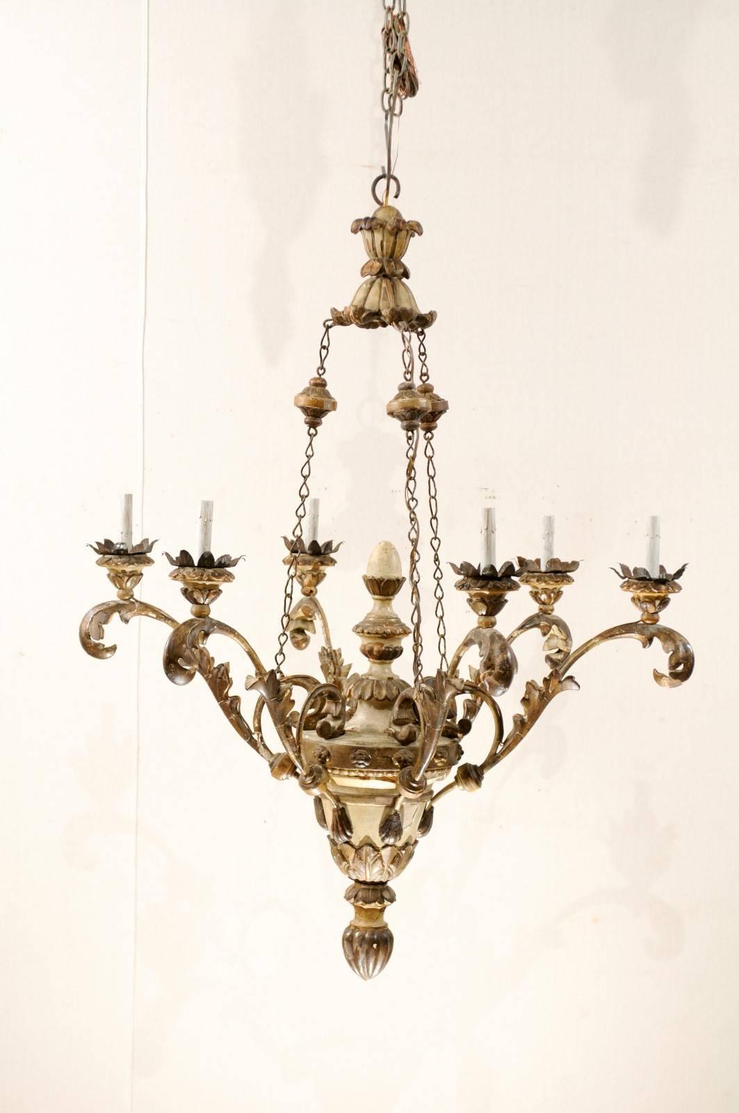 An exquisite pair of nice-sized Italian six-light chandeliers. This pair of early 20th century Italian chandeliers are simply breathtaking and together make quite an impactful statement. Their wooden urn shaped bodies give rise to six splayed arms,