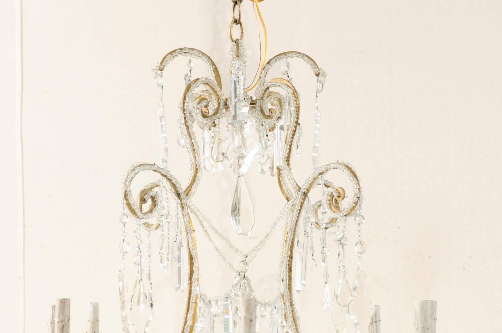 Beaded Italian Eight-Light Crystal and Gilded Iron Chandelier with Ornate Scroll Design