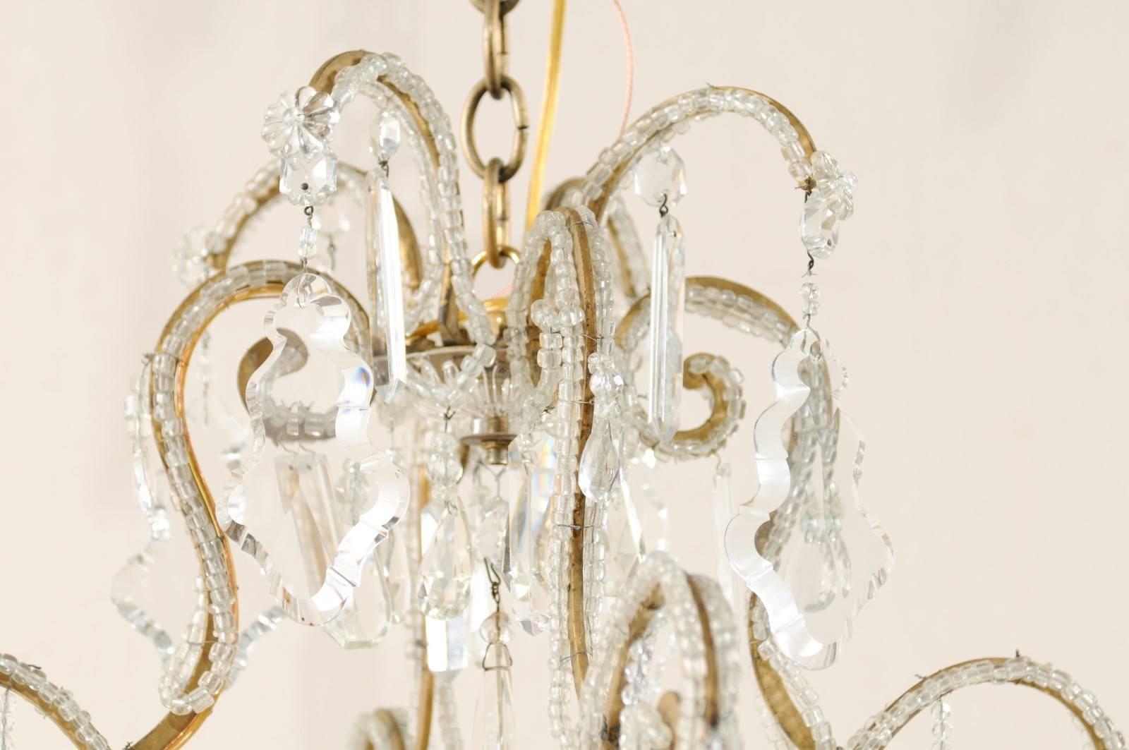 Italian Eight-Light Crystal and Gilded Iron Chandelier with Ornate Scroll Design In Good Condition In Atlanta, GA