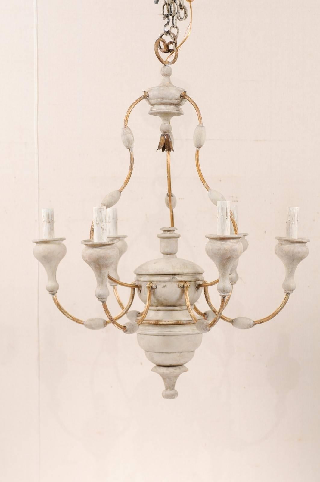 An Italian six-light painted wood and metal chandelier. This good sized mid-20th century Italian chandelier features a carved and painted wood column with metal swag arms extending out from the centre. Each arm metal arm features an oblong bead