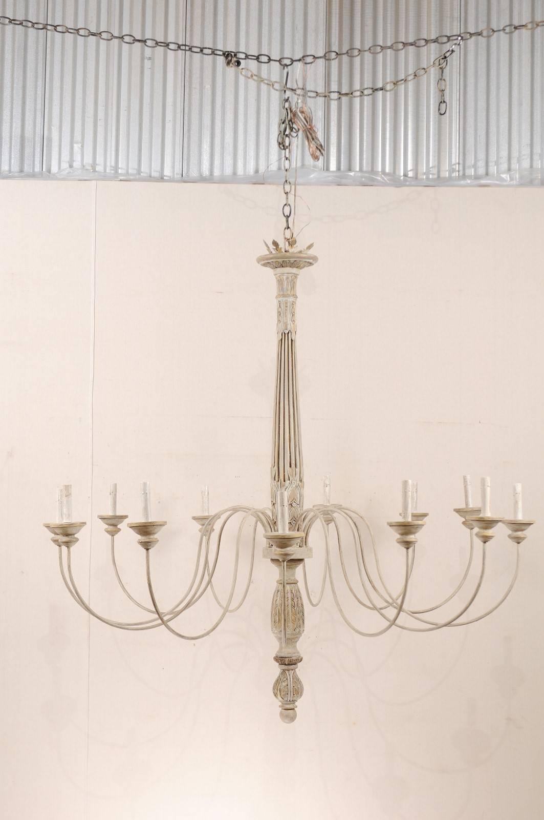 A large sized custom twelve-light painted wood and metal chandelier. This exquisite mid-20th century chandelier has been custom-made from old Italian fragments. This chandelier features a fluted and carved wood column with fluid s-shaped swooping