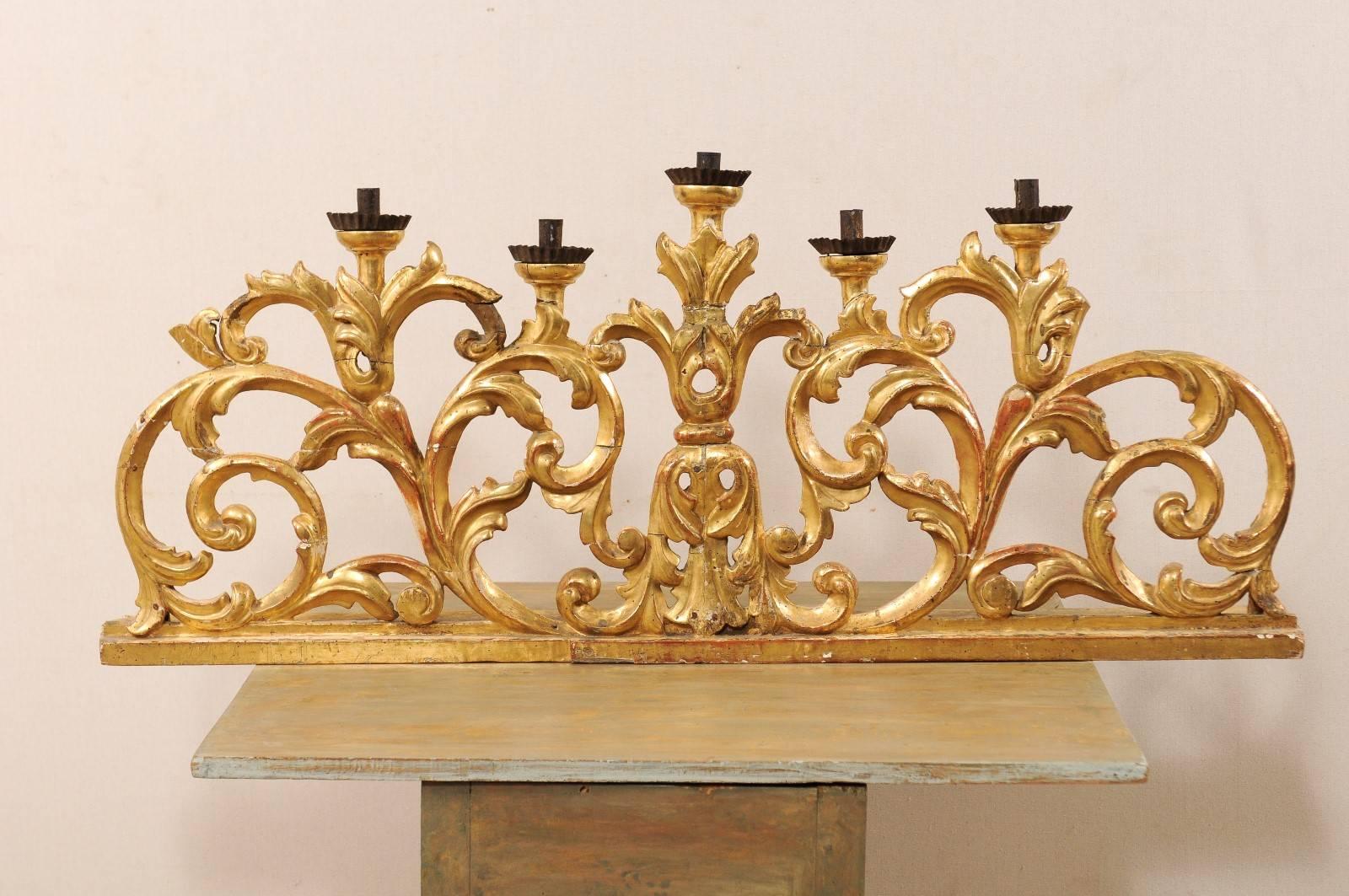 A large pair of Italian 19th century five-light candelabra. This pair of richly carved five-candlestick light candelabras feature gesso and gilt over wood with a beautiful scrolling acanthus leaf motif. The candelabras would work well centered on a