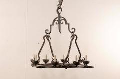 French Mid-Century Eight-Light Forged Iron Chandelier with Hooks and Scrolls