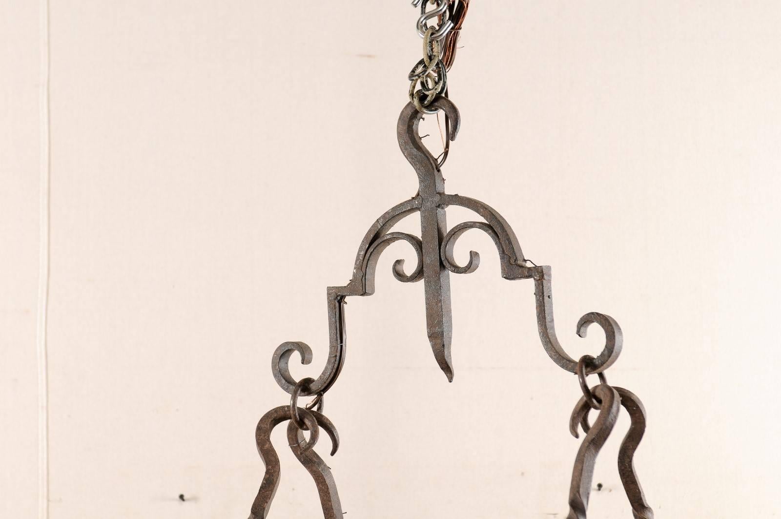 19th Century French Mid-Century Eight-Light Forged Iron Chandelier with Hooks and Scrolls For Sale