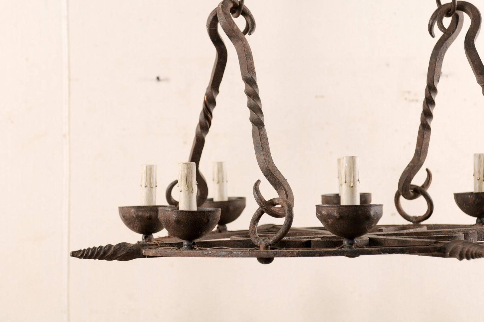 French Mid-Century Eight-Light Forged Iron Chandelier with Hooks and Scrolls For Sale 1