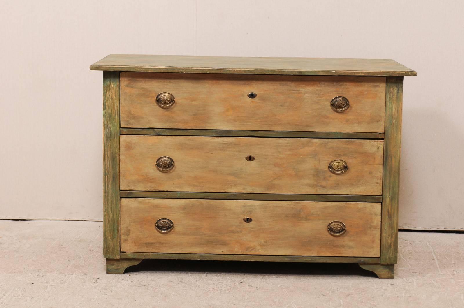 A Swedish three-drawer chest from the 19th century. This Swedish, 19th century painted wood chest features a subtle faux painted marble top over three dovetail jointed drawers and is raised upon bracket feet. This chest has a lightly washed finish,